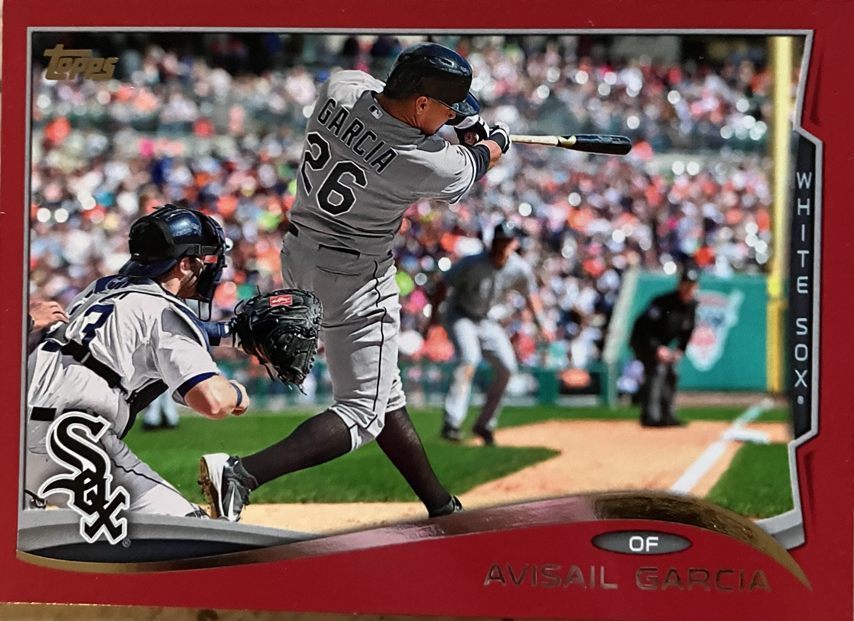 A baseball player post-swing after just hitting a ball.