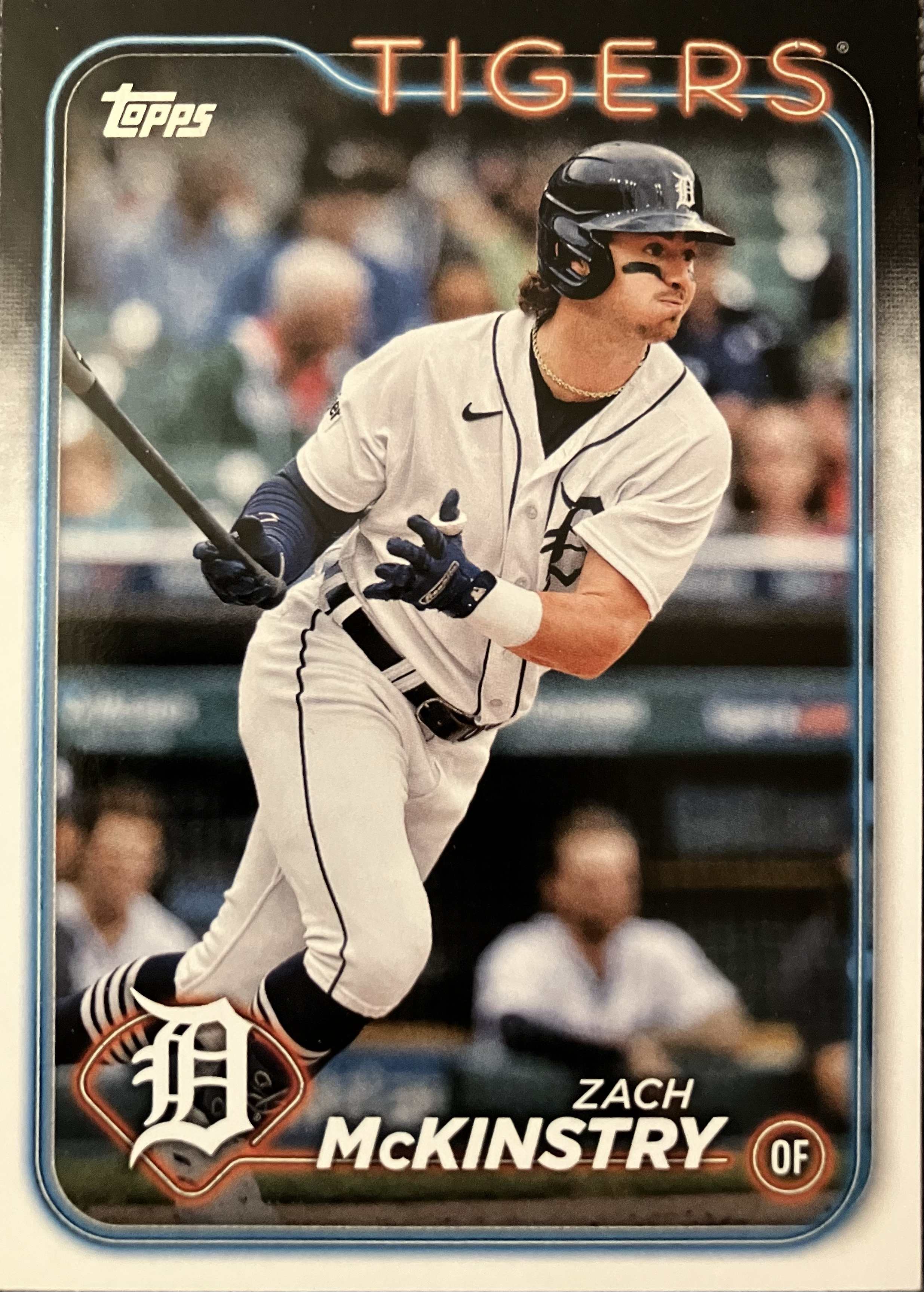 A baseball player drops his bat and leans forward to run.