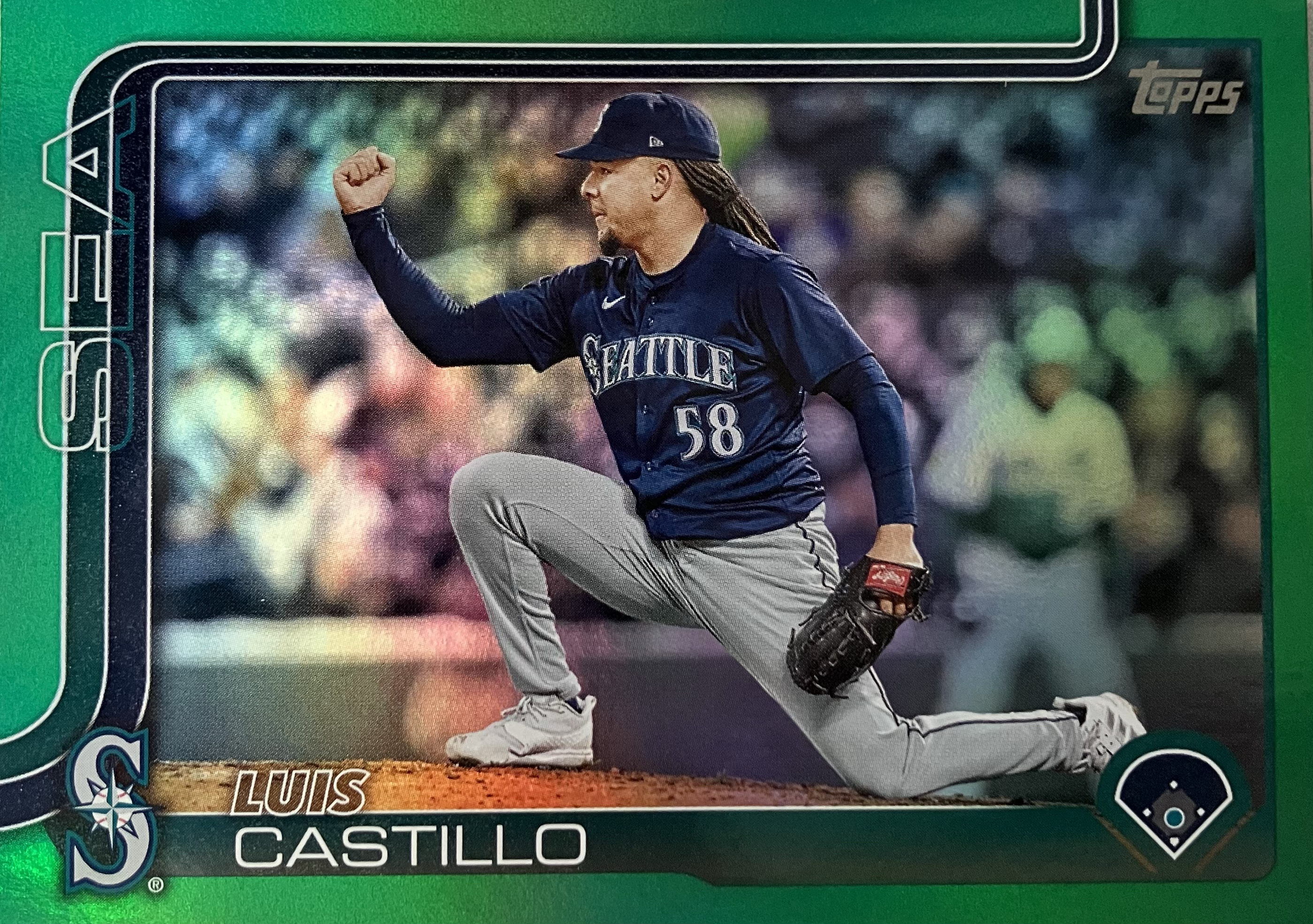 A baseball pitcher doing a lunge on one knee in celebration.