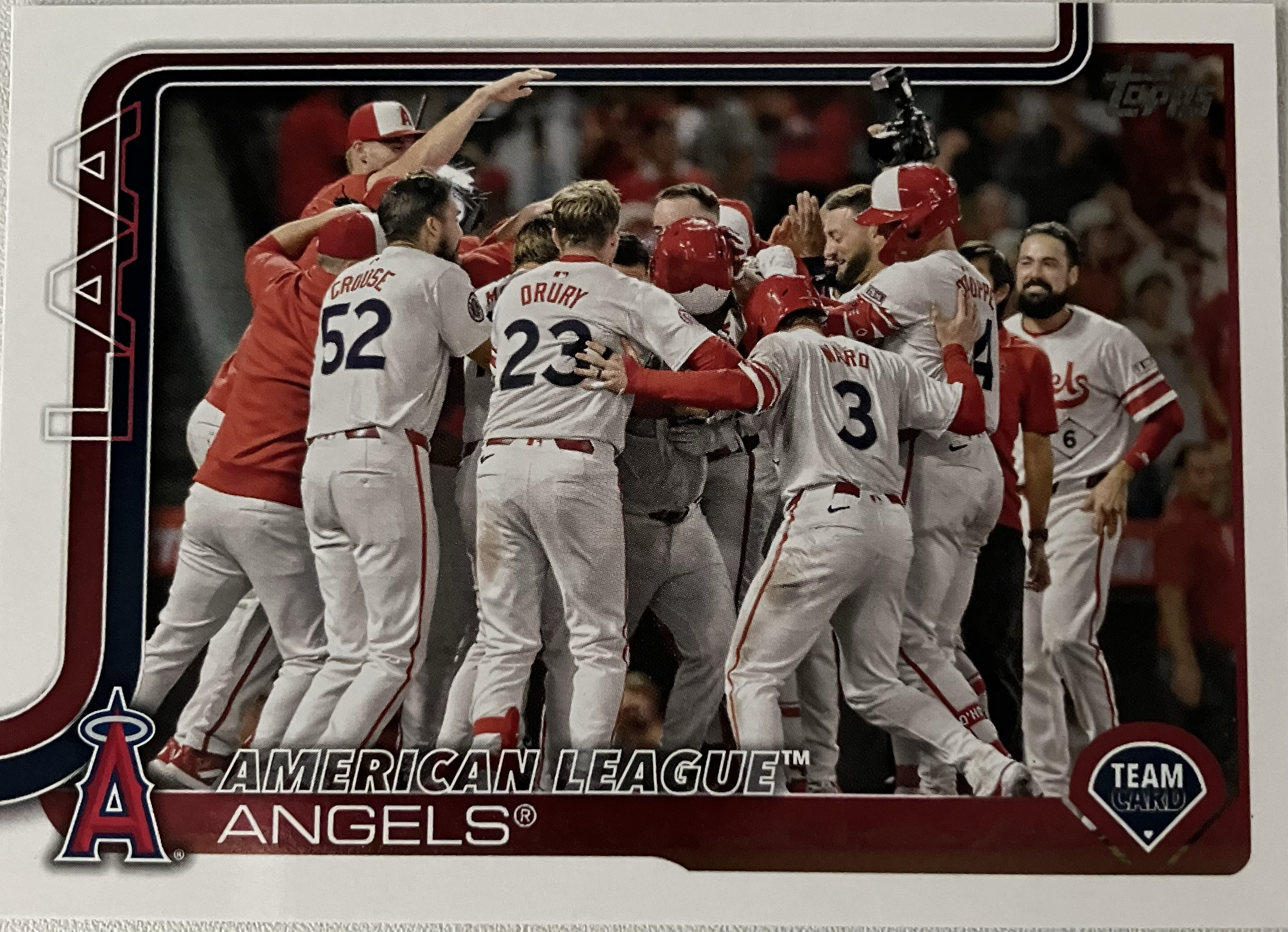 The Angels baseball team celebrating a walkoff with several players in a large group.