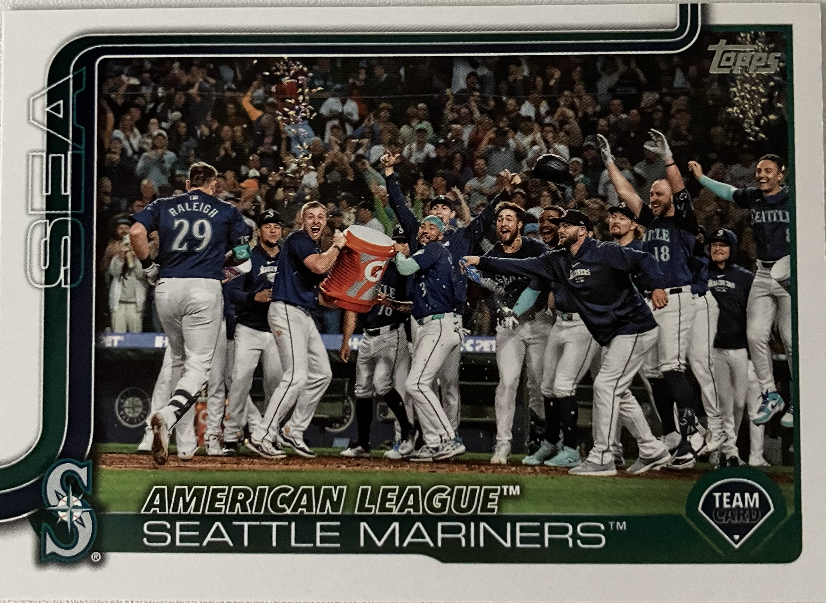 The Mariners baseball team celebrating a walkoff with several players in a large group.