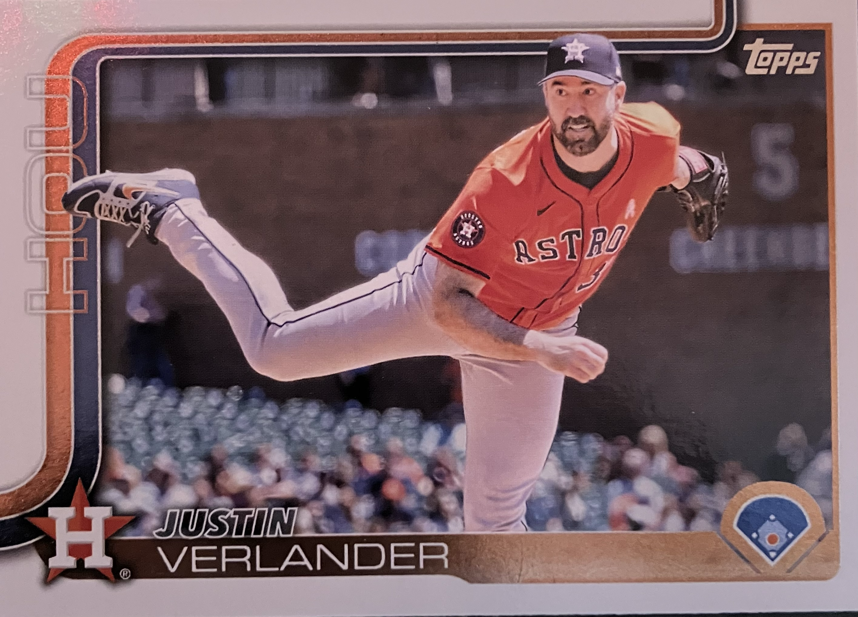 A baseball player throws a pitch in the sunshine.