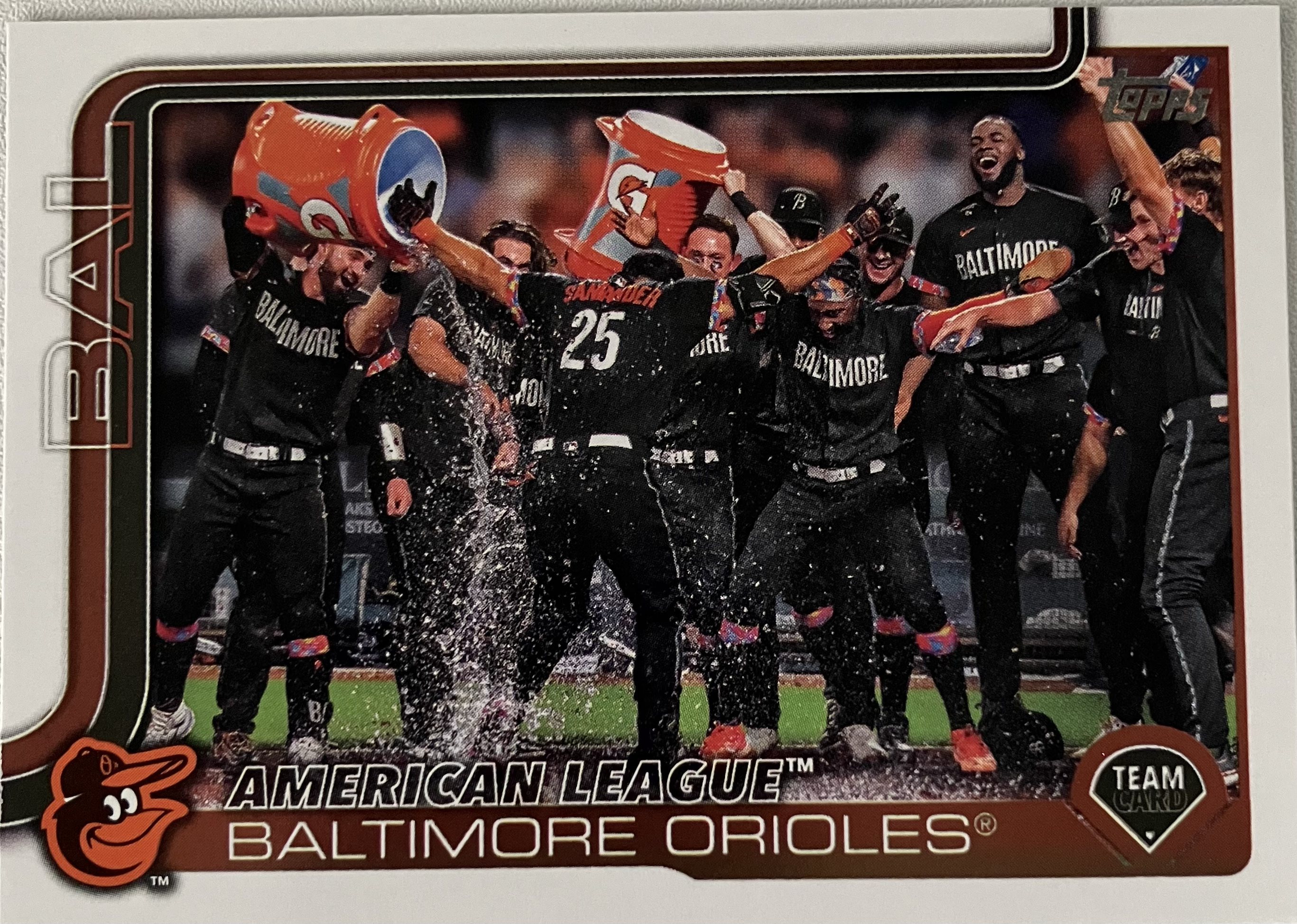 The Orioles baseball team celebrating a walkoff with several players in a large group.