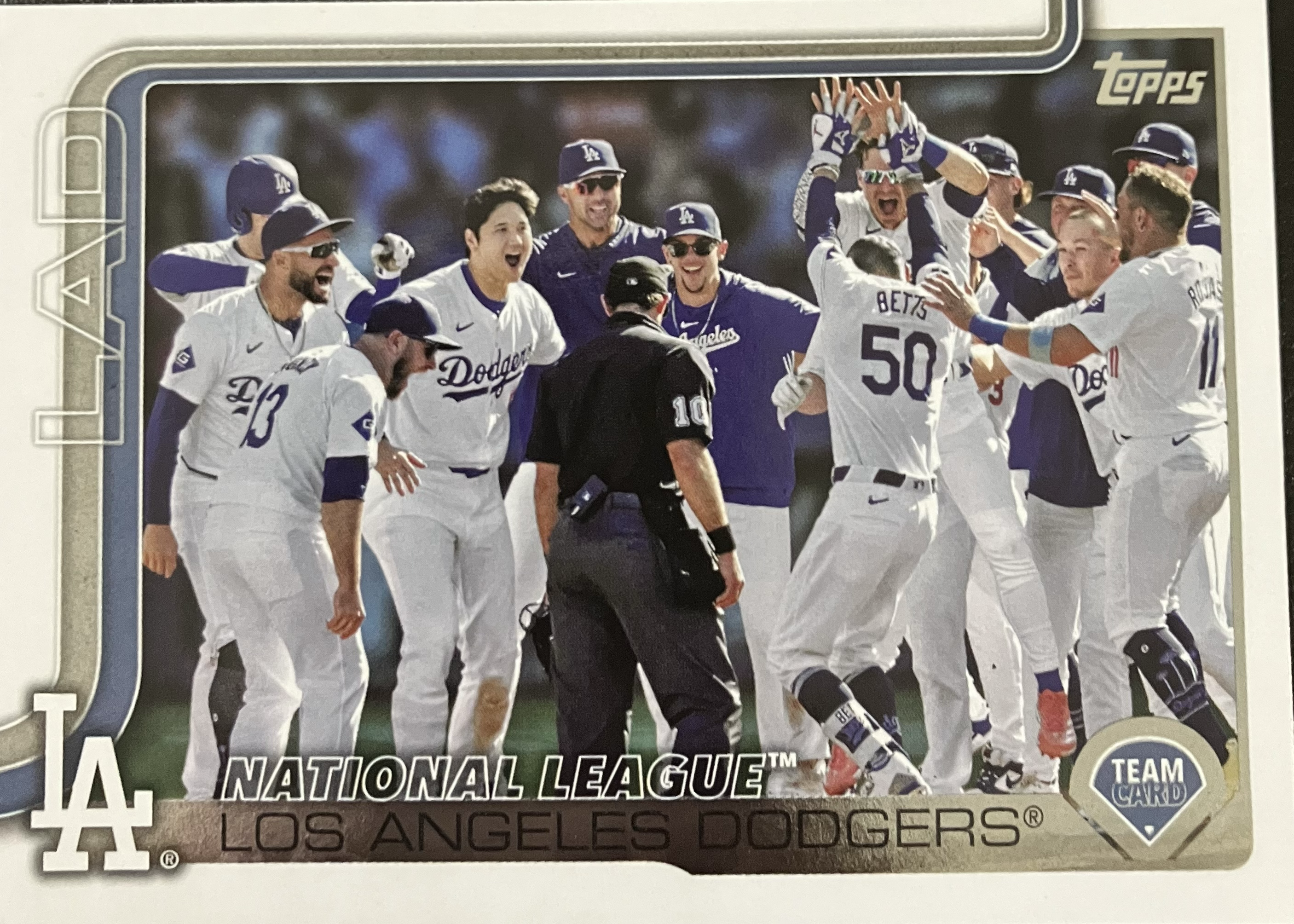 The Dodgers baseball team celebrating a walkoff with several players in a large group.
