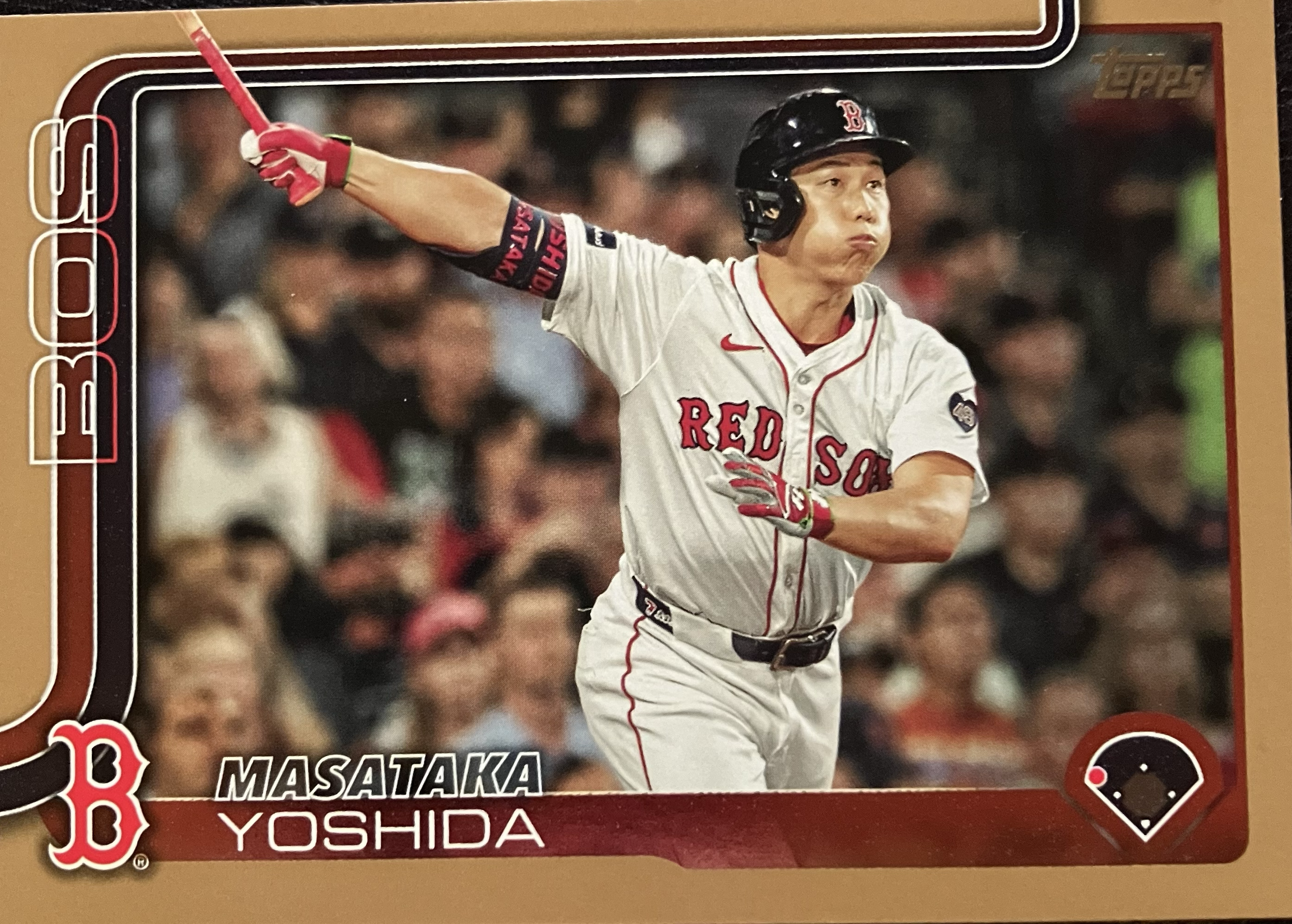 A baseball player just after he hit a ball, cheeks puffed from the effort.