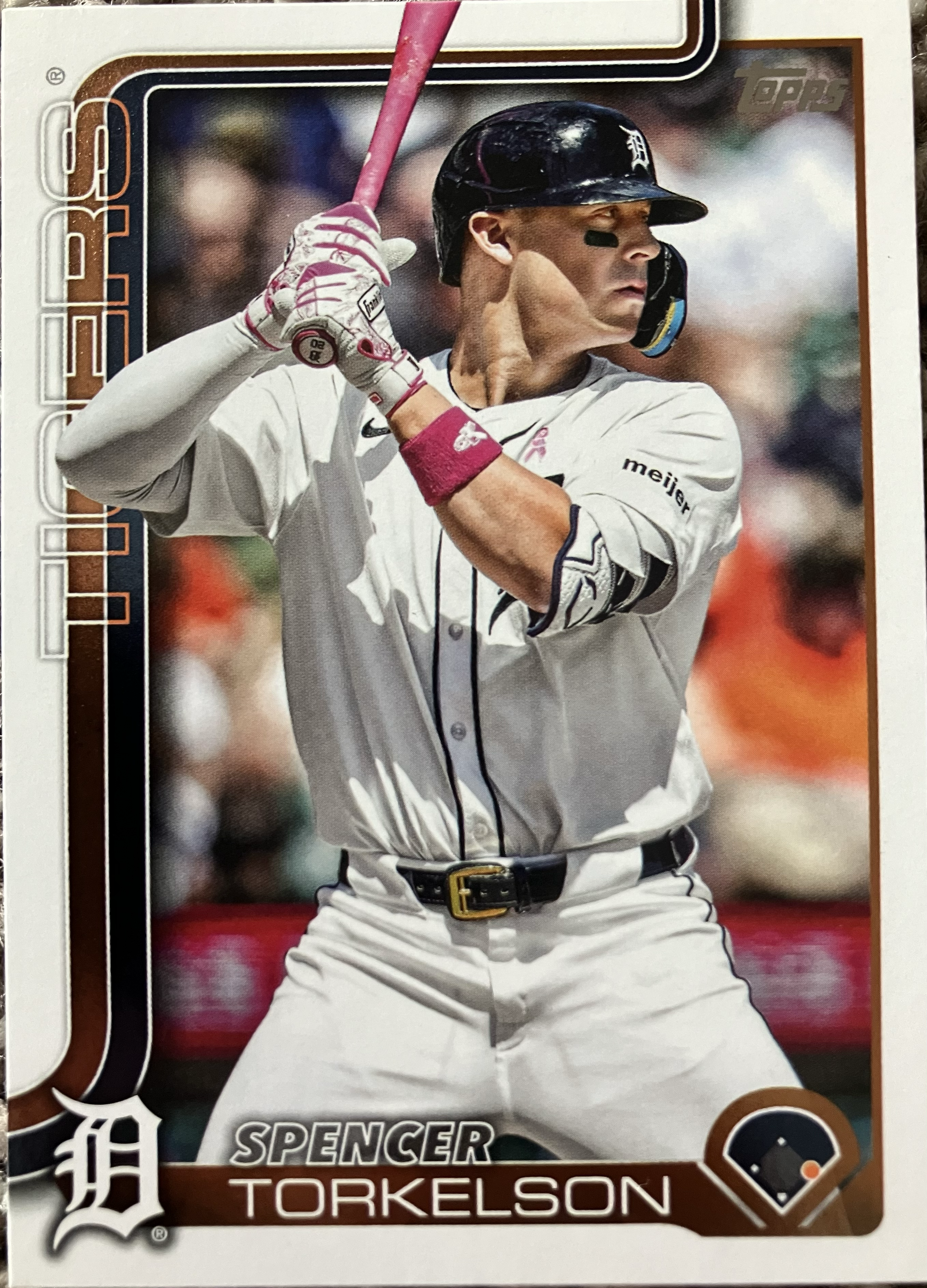 A player holding a pink bat waiting for a pitch.