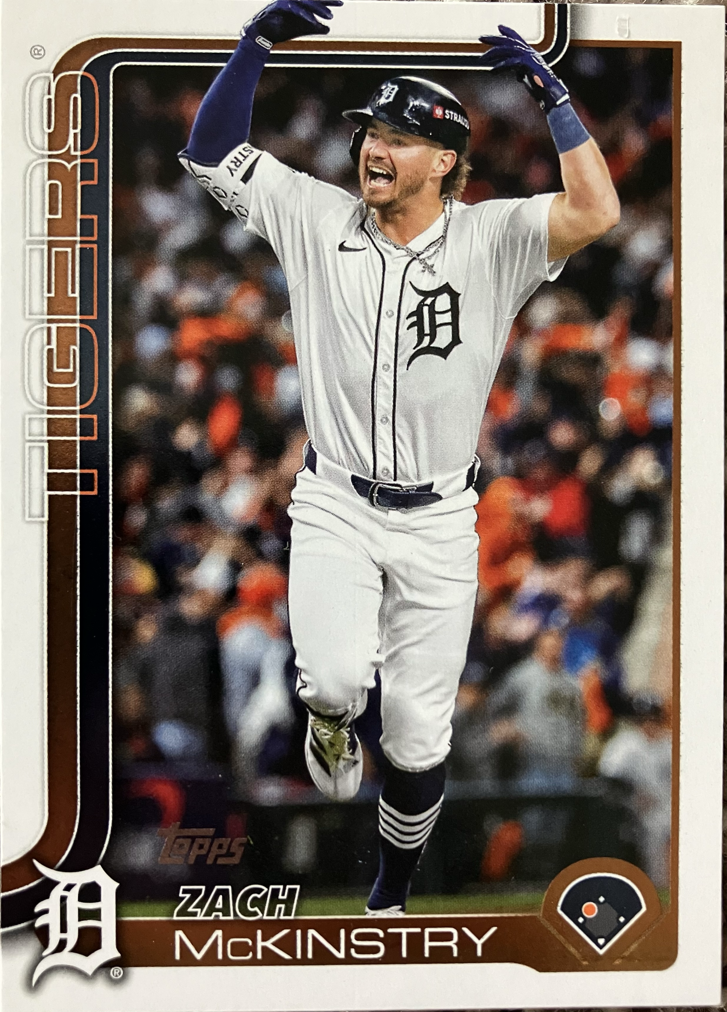 A player with his hands in the air in celebration as he rounds the bases.