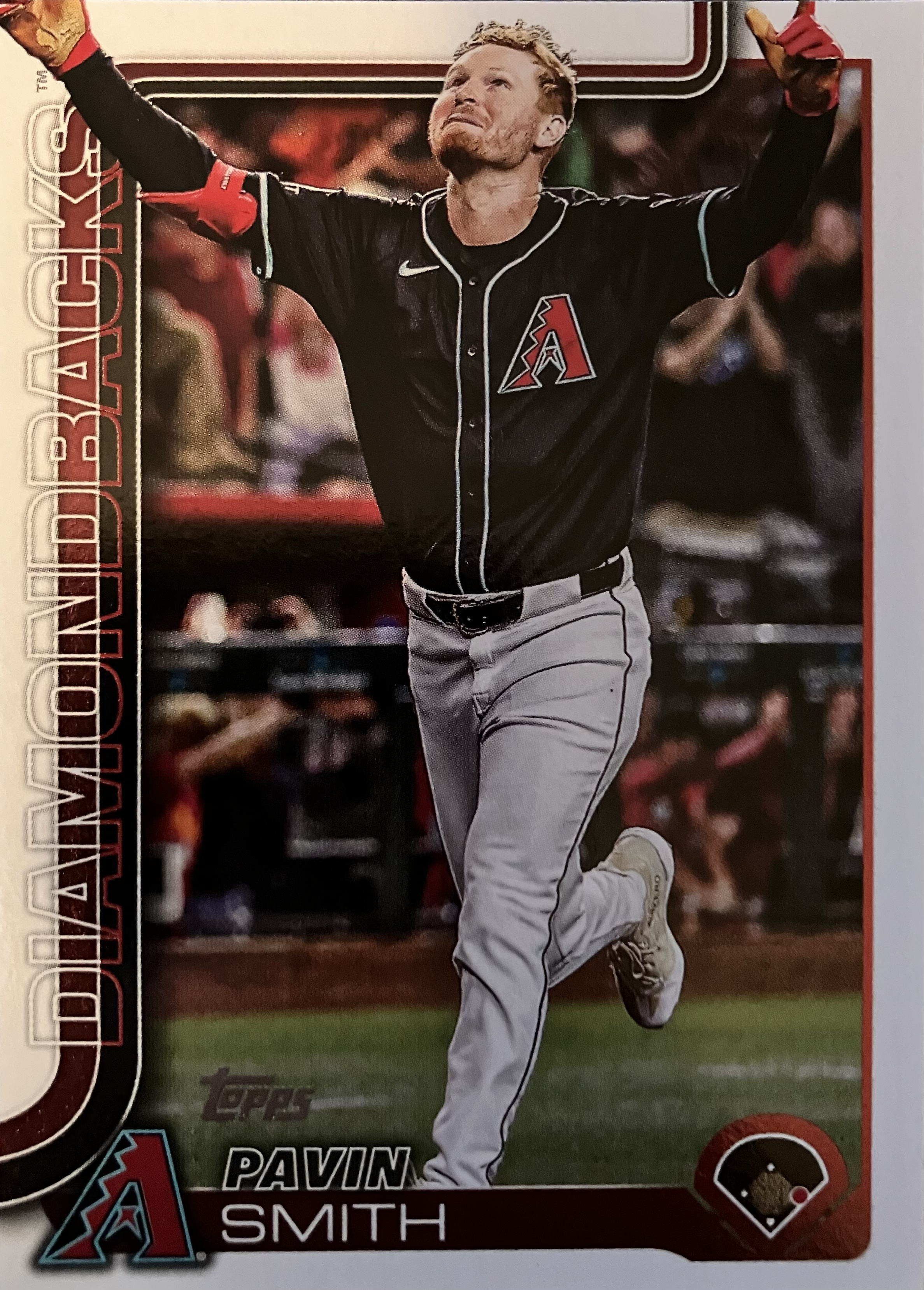 A player with his hands in the air in celebration as he rounds the bases.